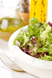 Fresh salad with dressing on the side.