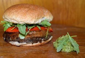 Vegetarian burger with arugula and pesto.