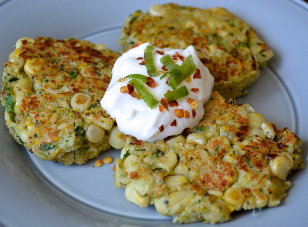 Corn fritters topped with sour cream and herbs.