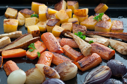 Roasted assorted vegetables on a baking tray.