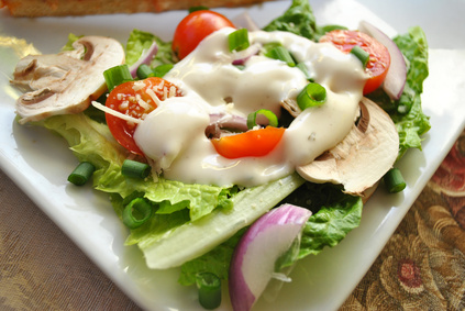 Fresh salad with dressing and vegetables.