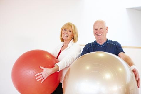 Seniors smiling with exercise balls.